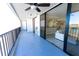 Large balcony featuring tile floor, patio seating, sliding glass doors, and waterfront views at 19111 Vista Bay Dr # 401, Indian Shores, FL 33785
