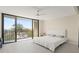 Bright bedroom featuring a balcony with scenic outdoor views, neutral walls, and wood-look flooring at 19111 Vista Bay Dr # 401, Indian Shores, FL 33785