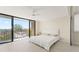 Bright bedroom featuring a balcony with scenic outdoor views, neutral walls, and wood-look flooring at 19111 Vista Bay Dr # 401, Indian Shores, FL 33785