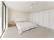 Bright bedroom featuring a closet, neutral walls, and wood-look flooring at 19111 Vista Bay Dr # 401, Indian Shores, FL 33785