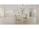 The dining area is open to the living room with a chandelier and natural light at 19111 Vista Bay Dr # 401, Indian Shores, FL 33785