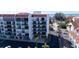 Low-rise condos with red tile roof offer balconies, covered parking, and mature palm trees at 19111 Vista Bay Dr # 401, Indian Shores, FL 33785