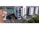 Condos with red tile roof offer bay views, multiple balconies, covered parking, and tropical landscaping at 19111 Vista Bay Dr # 401, Indian Shores, FL 33785