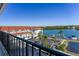 Scenic building exterior with red roof, waterfront views, parking, and lush tropical palm trees at 19111 Vista Bay Dr # 401, Indian Shores, FL 33785