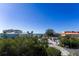 Charming building exterior surrounded by lush greenery and clear blue skies at 19111 Vista Bay Dr # 401, Indian Shores, FL 33785