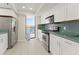 Modern kitchen with white cabinets, stainless steel appliances, and a view of the water at 19111 Vista Bay Dr # 401, Indian Shores, FL 33785