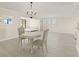 The bright open floorplan connects to the bedroom and features light wood-look floors and a modern chandelier at 19111 Vista Bay Dr # 401, Indian Shores, FL 33785
