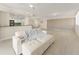 Open-concept living room features light, neutral colors, modern ceiling fan, and access to the kitchen and dining area at 19111 Vista Bay Dr # 401, Indian Shores, FL 33785