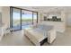 Living room featuring a balcony with scenic outdoor views, neutral walls, and wood-look flooring at 19111 Vista Bay Dr # 401, Indian Shores, FL 33785