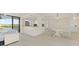 Open living room featuring a breakfast bar, dining area, and a view of the water at 19111 Vista Bay Dr # 401, Indian Shores, FL 33785