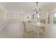 Open-concept living and dining area with neutral tones, flooded with natural light, and offering a view of the waterway at 19111 Vista Bay Dr # 401, Indian Shores, FL 33785