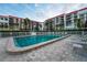 Beautiful in-ground pool surrounded by a well-maintained deck and lush landscaping, ideal for community enjoyment at 19111 Vista Bay Dr # 401, Indian Shores, FL 33785