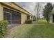 This is a backyard view of the enclosed lanais with grassy lawn and landscaping at 2007 Hawks View Dr, Ruskin, FL 33570
