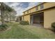 This is a backyard view of the enclosed lanais with grassy lawn and landscaping at 2007 Hawks View Dr, Ruskin, FL 33570