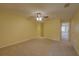 A bright, carpeted bedroom with a ceiling fan and neutral decor at 2007 Hawks View Dr, Ruskin, FL 33570