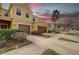 Townhome with two-car garage on a sunny day featuring a well-manicured lawn, an ample driveway, and mature palm trees at 2007 Hawks View Dr, Ruskin, FL 33570