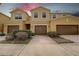 Inviting exterior view of the townhome featuring a two-car garage, well-maintained landscaping, and a neutral color palette at 2007 Hawks View Dr, Ruskin, FL 33570
