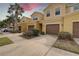 Sunny view of several townhomes, showcasing the well-kept landscaping, driveways, and architectural details at 2007 Hawks View Dr, Ruskin, FL 33570