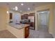 Modern kitchen with granite countertops, stainless steel appliances, and tile flooring, creating a stylish and functional space at 2007 Hawks View Dr, Ruskin, FL 33570