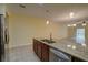 Spacious kitchen featuring granite countertops, stainless steel appliances, and views of the adjacent living and dining areas at 2007 Hawks View Dr, Ruskin, FL 33570