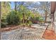 Backyard featuring a wooden deck, stone patio, and lush greenery, ideal for relaxation and outdoor activities at 2207 Boxwood Way, Brandon, FL 33511