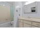 This bathroom features a vanity with a sink, a mirror and a combined tub and shower, simple and very functional at 2207 Boxwood Way, Brandon, FL 33511