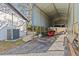 Covered carport providing ample space for boat and kayak storage, with convenient access to the property at 2207 Boxwood Way, Brandon, FL 33511