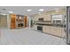 Open kitchen layout with a stone fireplace, built-in shelves, and modern appliances at 2207 Boxwood Way, Brandon, FL 33511