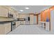 This spacious kitchen has stainless steel appliances, lots of countertop space, and light colored cabinets with dark handles at 2207 Boxwood Way, Brandon, FL 33511