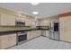 The modern kitchen has stainless steel appliances, granite countertops, tiled backsplash, and ample cabinet space at 2207 Boxwood Way, Brandon, FL 33511