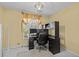 This office has a contemporary black desk with lots of workspace, a black ergonomic chair and a nice view outside at 2207 Boxwood Way, Brandon, FL 33511