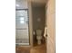 Bathroom featuring a walk-in shower, toilet, and a door to the rest of the house at 2235 20Th St S, St Petersburg, FL 33712