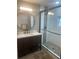 Modern bathroom featuring a dark vanity, walk-in shower, and stylish fixtures at 2235 20Th St S, St Petersburg, FL 33712