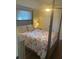 Comfortable bedroom featuring a four-poster bed with floral comforter, ceiling fan, and window at 2235 20Th St S, St Petersburg, FL 33712