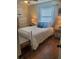 Cozy bedroom with wood floors, a comfortable bed, and natural lighting at 2235 20Th St S, St Petersburg, FL 33712