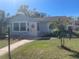 Charming home with a well-manicured lawn, brick walkway, and a palm tree in the front yard at 2235 20Th St S, St Petersburg, FL 33712