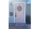 Close-up of a charming pink front door with a decorative wreath and a 'Welcome' mat at 2235 20Th St S, St Petersburg, FL 33712