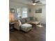 Inviting living room with sectional couch, wood floors, and views into dining area at 2235 20Th St S, St Petersburg, FL 33712