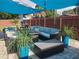 Back patio featuring cozy outdoor seating under a blue canopy with string lights and stylish potted plants at 2235 20Th St S, St Petersburg, FL 33712