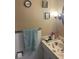 Bathroom with updated fixtures, neutral decor, and a mirrored vanity at 2700 Bayshore Blvd # 2308, Dunedin, FL 34698