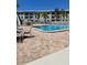 Inviting community pool surrounded by lounge chairs and palm trees at 2700 Bayshore Blvd # 2308, Dunedin, FL 34698