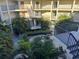 Scenic courtyard view featuring tropical landscaping, walkways, and multi-story buildings with balconies and stairwells at 2700 Bayshore Blvd # 2308, Dunedin, FL 34698