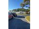 View of parked cars and driveway with an ocean view at the end at 2700 Bayshore Blvd # 2308, Dunedin, FL 34698