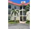 Well-maintained condominium exterior with lush landscaping and covered walkways at 2700 Bayshore Blvd # 2308, Dunedin, FL 34698