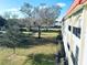 Scenic exterior view with a building featuring a red roof and a large tree in a grassy area at 2700 Bayshore Blvd # 2308, Dunedin, FL 34698