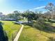 Picturesque view of the community grounds featuring lush greenery, trees, pool, and a walking path at 2700 Bayshore Blvd # 2308, Dunedin, FL 34698