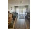 Bright living room featuring hardwood flooring, a comfortable couch, and sheer curtains at 2700 Bayshore Blvd # 2308, Dunedin, FL 34698