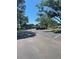 Exterior view of a parking lot with mature trees surrounding the building at 2700 Bayshore Blvd # 2308, Dunedin, FL 34698