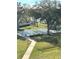 A covered swimming pool with surrounding benches and lush greenery viewed from an elevated position at 2700 Bayshore Blvd # 2308, Dunedin, FL 34698