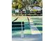 Outdoor shuffleboard courts with benches, greenery, and nearby buildings in the community at 2700 Bayshore Blvd # 2308, Dunedin, FL 34698